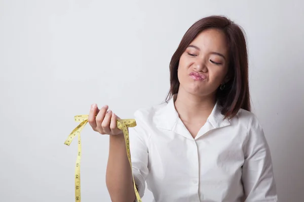 Ongelukkige jonge Aziatische vrouw met meetlint. — Stockfoto