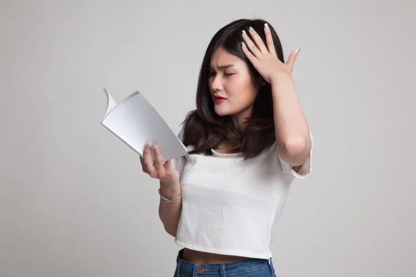 Joven asiática mujer got headache leer un libro . —  Fotos de Stock