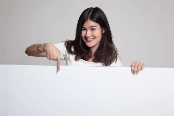 Young Asian woman point to a  blank sign. — Stock Photo, Image