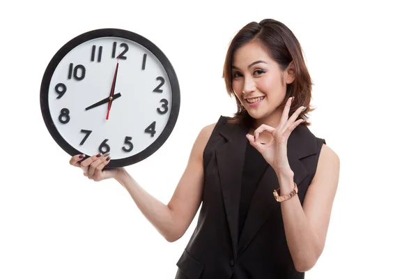 Young Asian woman show OK with a clock. — Stock Photo, Image