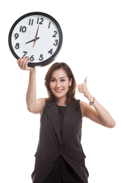 Joven mujer de negocios asiática pulgares arriba con un reloj . Fotos de stock