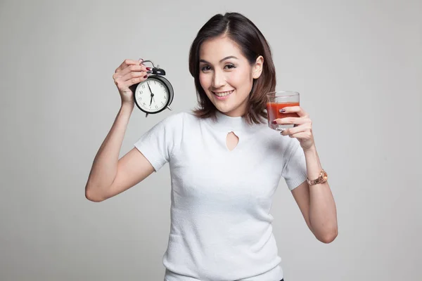 トマト ジュースおよび時計の若いアジア女性. — ストック写真
