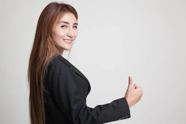 Young Asian woman turn back thumbs up. — Stock Photo, Image