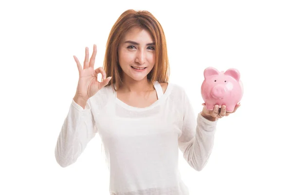 Asian woman show OK  with pig coin bank. — Stock Photo, Image