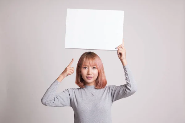 Jovem mulher asiática apontar para sinal em branco . — Fotografia de Stock