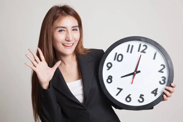 Happy Young Asian woman with a clock. — Stock Photo, Image