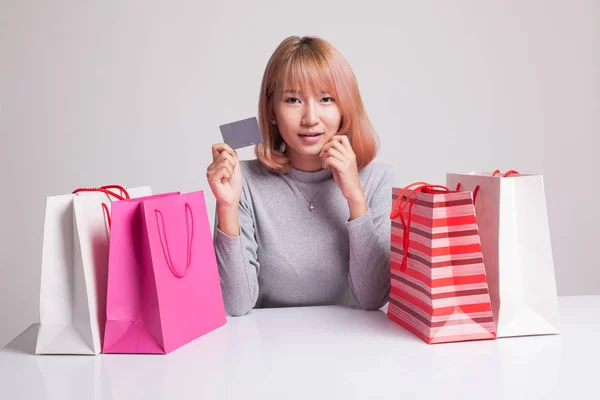 Young Asian woman with shopping bag and blank card. — Stock Photo, Image