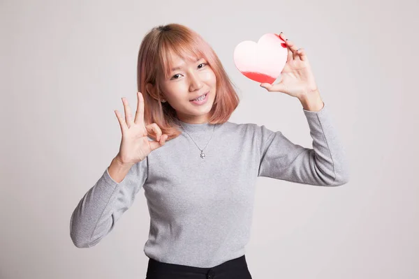 Asian woman show OK with red heart. — Stock Photo, Image