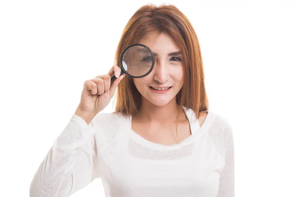 Young Asian woman with a magnifying glass. — Stock Photo, Image