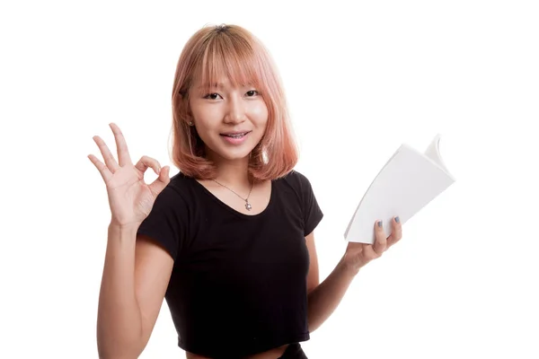Young Asian woman show OK with a book. — Stock Photo, Image
