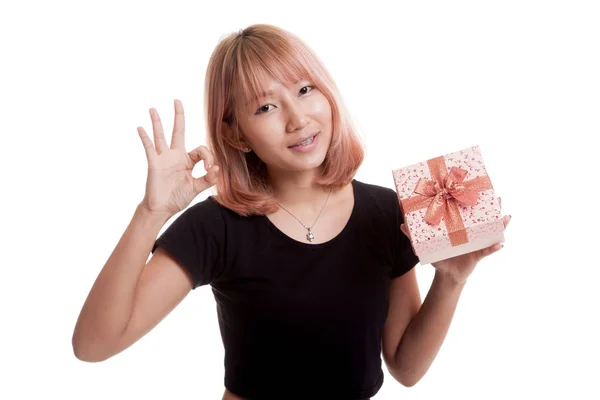 Young Asian woman show OK with a gift box. — Stock Photo, Image