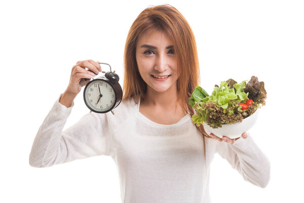 Young Asian woman with clock and salad.