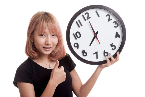 Young Asian woman thumbs up with a clock. — Stock Photo, Image