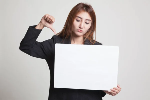 Young Asian woman show thumbs down with white blank sign. — Stock Photo, Image