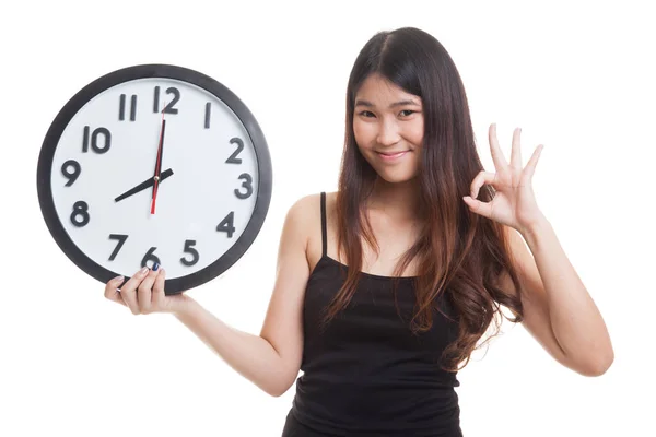 年轻的亚洲女人与时钟显示确定. — 图库照片