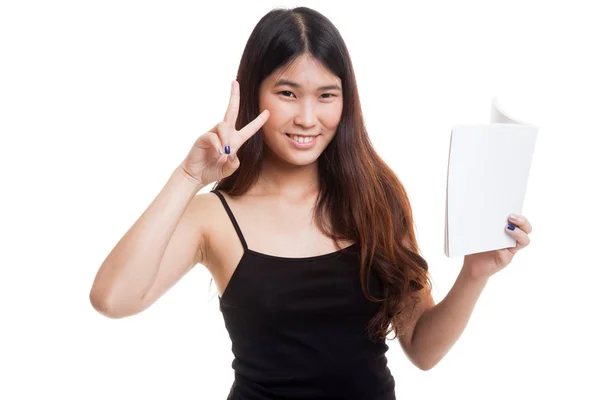Joven mujer asiática mostrar signo vencedor con un libro . —  Fotos de Stock