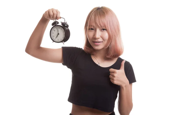 Jeune asiatique femme montrer pouces vers le haut avec une horloge . — Photo