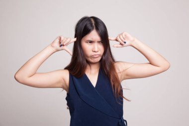 Genç Asyalı kadın parmakları ile her iki kulak engellemek.