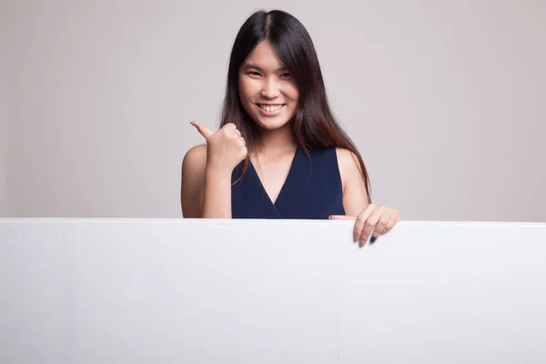 Young Asian woman show thumbs up with blank sign. — Stock Photo, Image