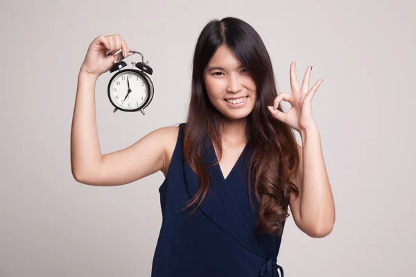 Νεαρή γυναίκα της Ασίας δείχνουν Ok με ένα ρολόι. — Φωτογραφία Αρχείου