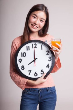 Asyalı kadın saati içki portakal suyu ile.