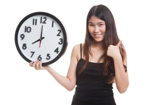 Young Asian woman thumbs up with a clock. — Stock Photo, Image