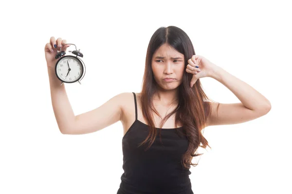 Young Asian woman thumbs down with a clock. — Stock Photo, Image