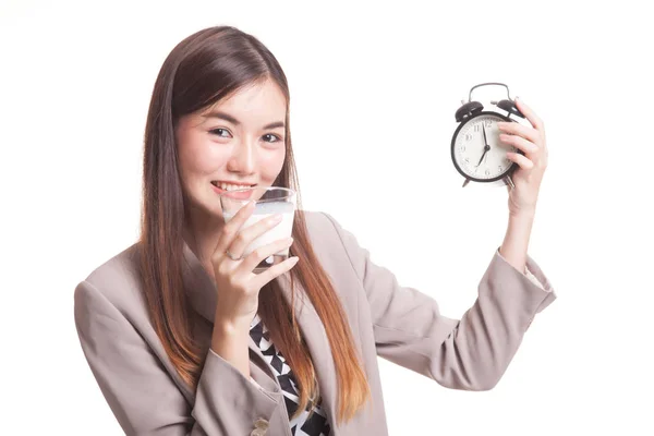 Healthy Asian woman drinking  glass of milk hold clock. — Stock Photo, Image