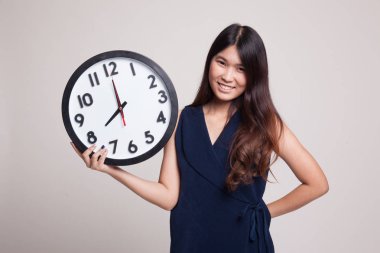 Saati olan genç Asyalı kadın..