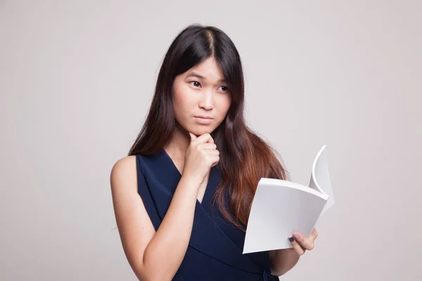 Młoda kobieta azjatyckich z książką jest myślenie. — Zdjęcie stockowe