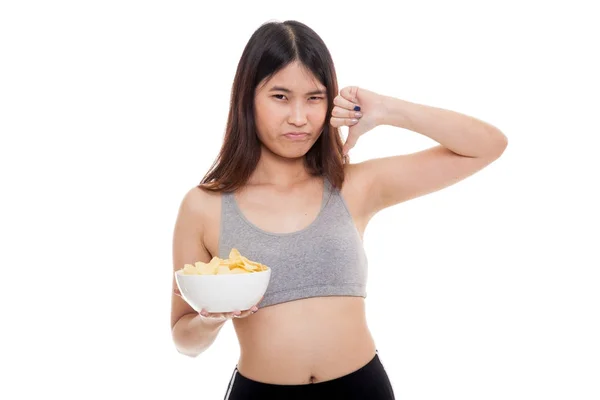 Asian healthy girl thumbs down with potato chips. — Stock Photo, Image
