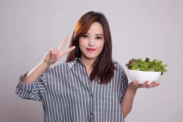 Femme asiatique saine montrent signe de victoire avec salade . — Photo