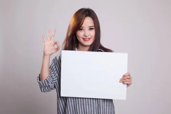 Young Asian woman show OK with white blank sign. — Stock Photo, Image