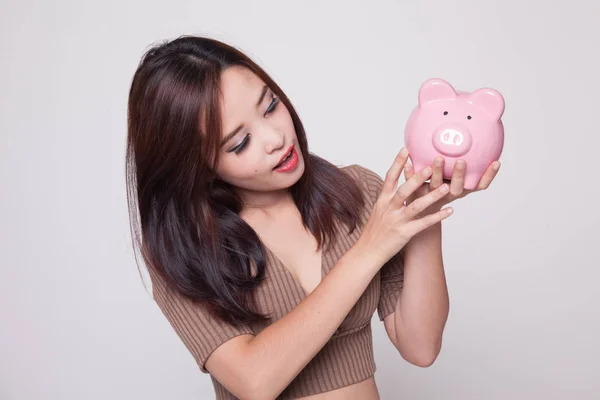 Young Asian woman with a pig coin bank. — Stock Photo, Image