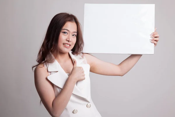 Young Asian woman show thumbs up with  white blank sign. — Stock Photo, Image