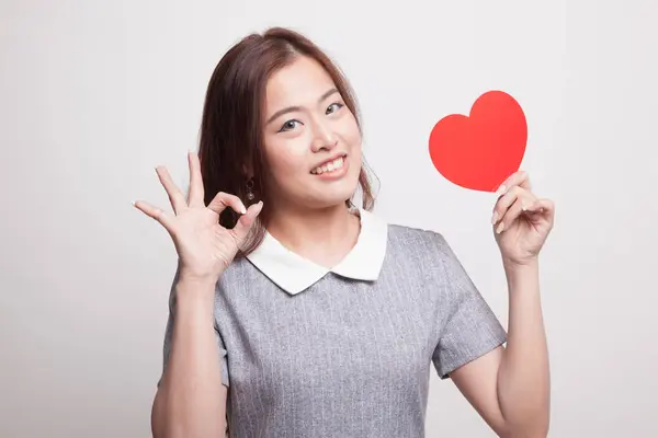 Asian woman show OK with red heart. — Stock Photo, Image