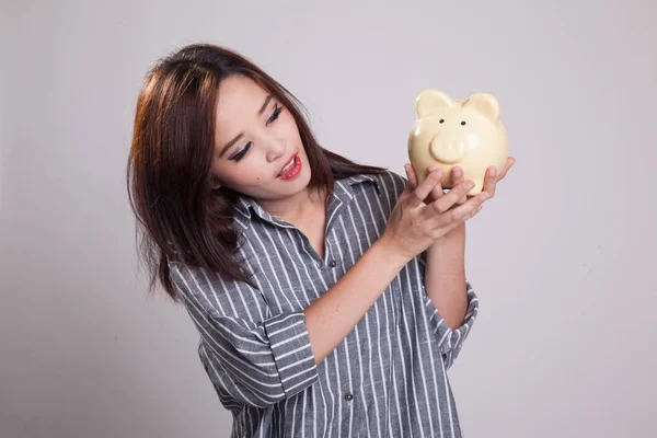 Young Asian woman with a pig coin bank. — Stock Photo, Image