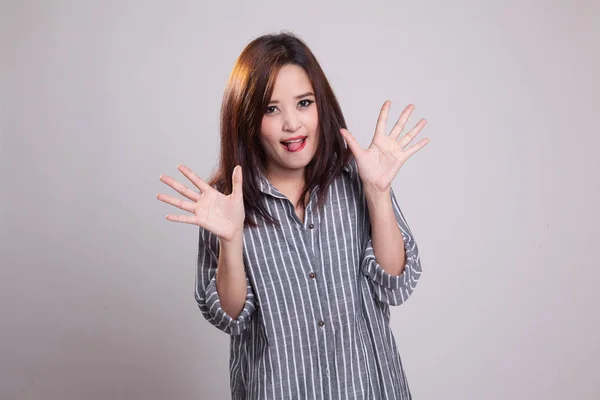 Young Asian woman sticking her  tongue out. — Stock Photo, Image