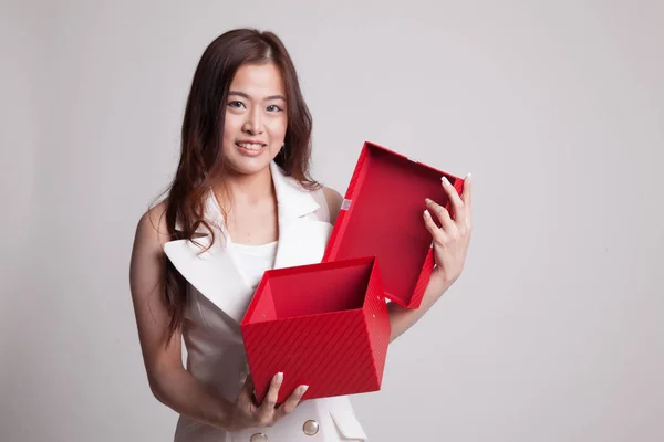 Young Asian woman open a golden gift box. — Stock Photo, Image