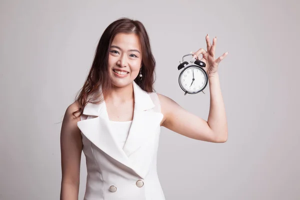 Young Asian woman with a clock. — Stock Photo, Image