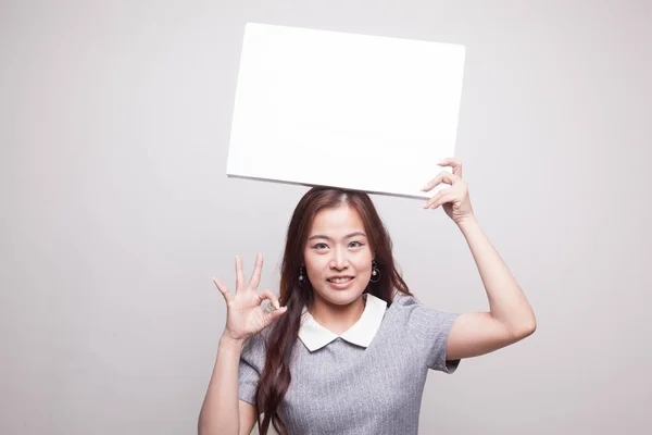 Young Asian woman show OK with  white blank sign. — Stock Photo, Image