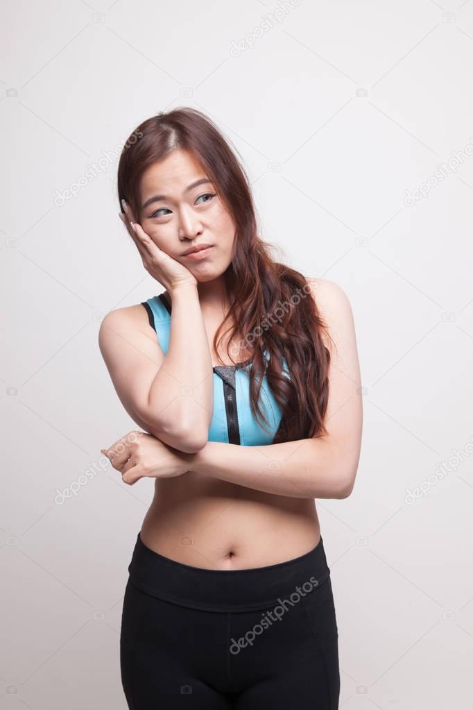 Beautiful young Asian woman in sport dress get bored.