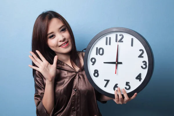 Happy Young Asian woman with a clock. — Stock Photo, Image