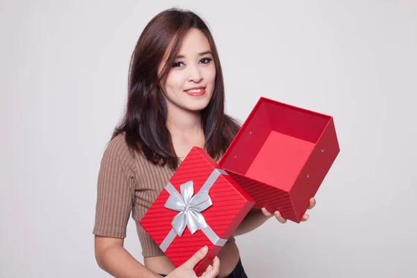 Young Asian woman open a golden gift box. — Stock Photo, Image