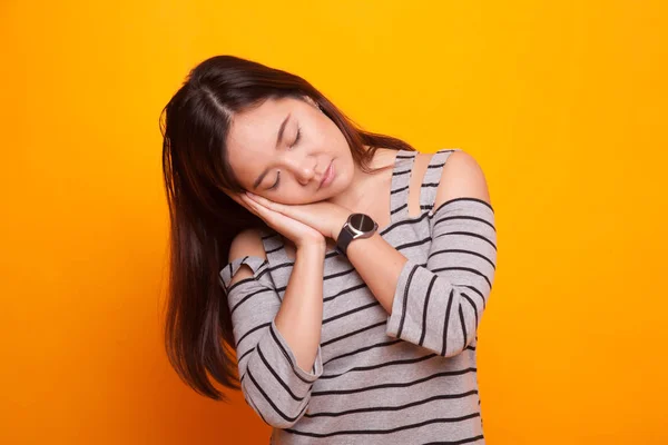 Beautiful young Asian woman with sleeping gesture. — Stock Photo, Image