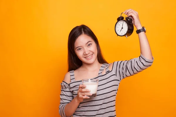 Femme asiatique en bonne santé boire verre de lait tenir horloge . — Photo