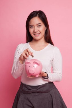 Sikke ve domuz para banka ile Asyalı kadın.