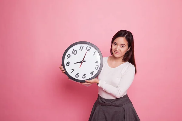 Jeune femme asiatique avec une horloge. — Photo