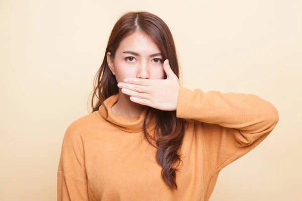 Junge asiatische Frau schließt ihren Mund mit der Hand. — Stockfoto