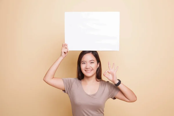 Young Asian woman show OK with  white blank sign. — Stock Photo, Image